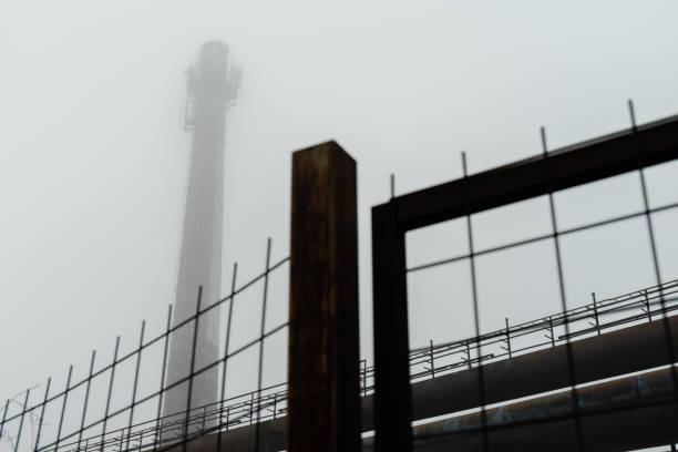 Tall industrial chimney in an abandoned industrial zone
