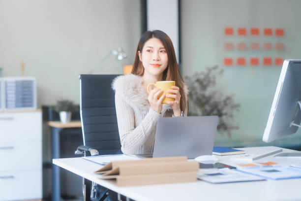 istock Young Asian professionals work as Business Analysts, Marketing Managers work at desk, analyzing financial charts and consulting on tax, business strategies, and project management. 2195425582