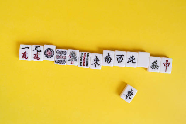 istock Mahjong tiles lined up on a yellow background 2195428201