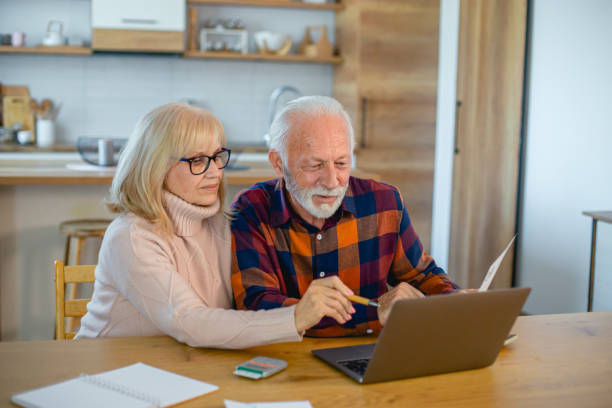 istock Senior couple using laptop while planning their home budget 2195428937