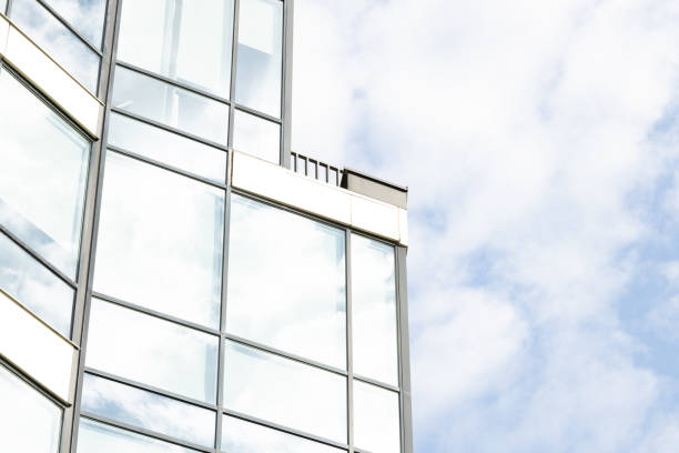 istock modern skyscraper office building external side of frame and glass windows frame work and neutral sky background space 2195429541