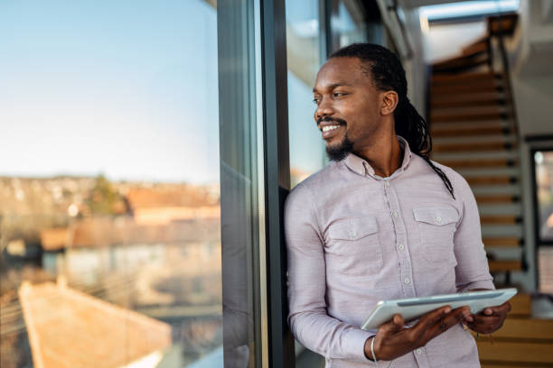 istock African man using digital device, tablet for online communication, education, work or social media 2195433845