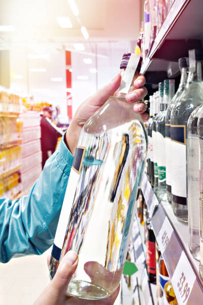 istock Bottle of vodka in hands 2195436816