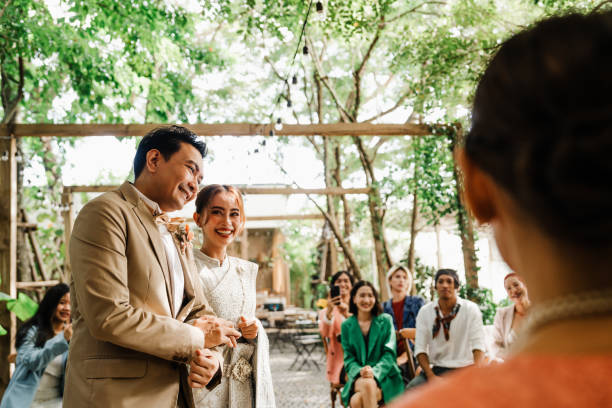 istock Joyful Father and Bride Walk Amid Applause at Outdoor Thai Wedding 2195437383