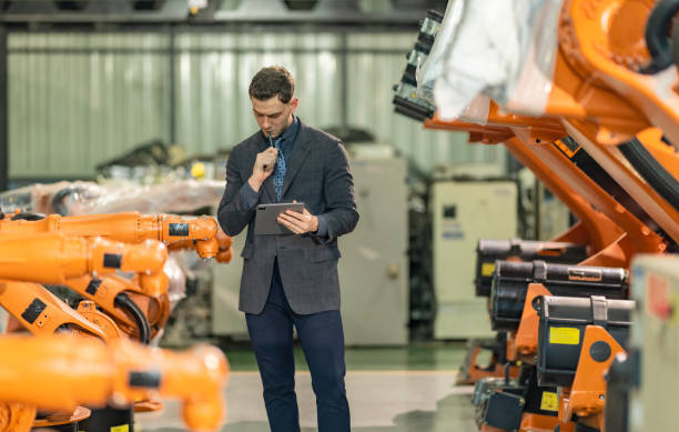 istock Factory Owner and Manager Inspecting Robotic Arm 2195437725