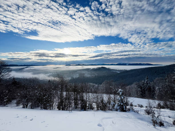 istock Serene snow-covered landscape under a vibrant sky with scattered clouds 2195437892