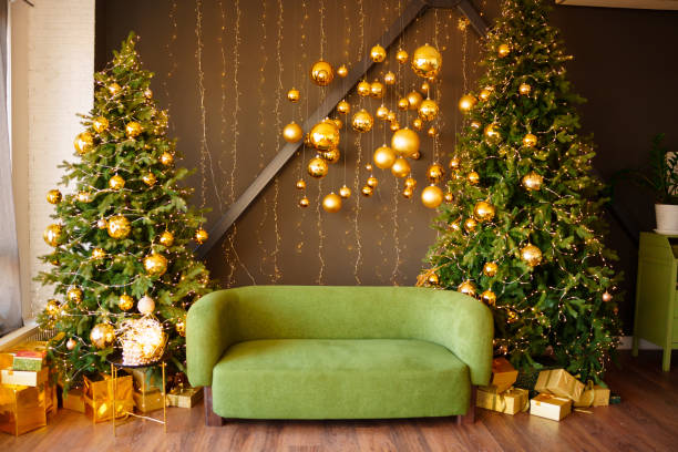 istock A green sofa in a room between Christmas trees. 2195438181