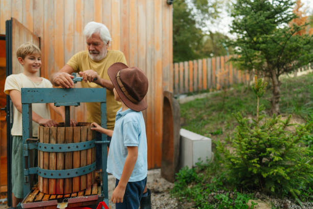 istock Pressing grapes with a wooden wine press outdoors 2195438472