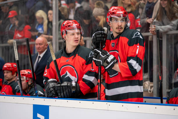 istock Focused Ice Hockey Players Watching Game Bench 2195438704