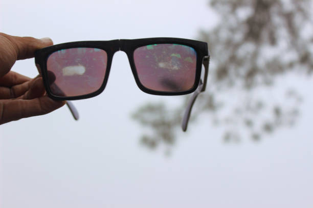 istock Perspective View Through Dusty Glasses Held Against a Blurred Background 2195438788