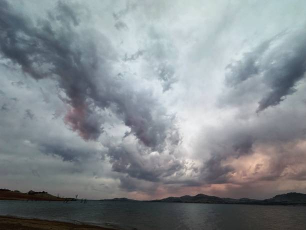 istock Beautiful dramatic sunset storm cloud over lake 2195438834
