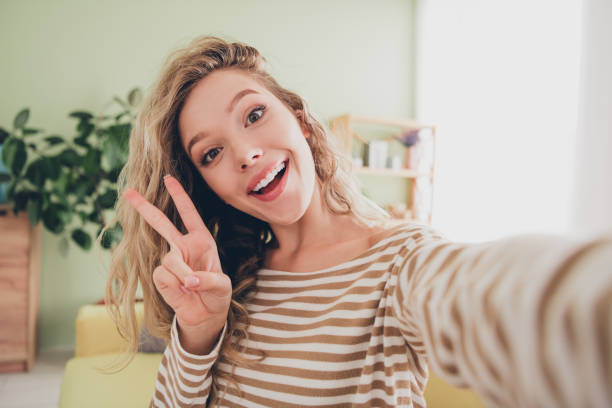 istock Charming young woman in a striped pullover enjoying a relaxed weekend indoors with a casual and happy smile 2195440412