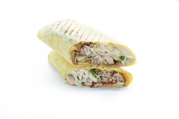 istock shawarma with chicken, sauce, pita bread, vegetables on a white background, isolate, fast food, salad, rosemary, tomato 2195440767