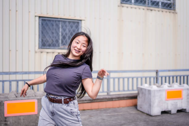 istock Enthusiastic female dancer dancing k-pop in the city 2195441075