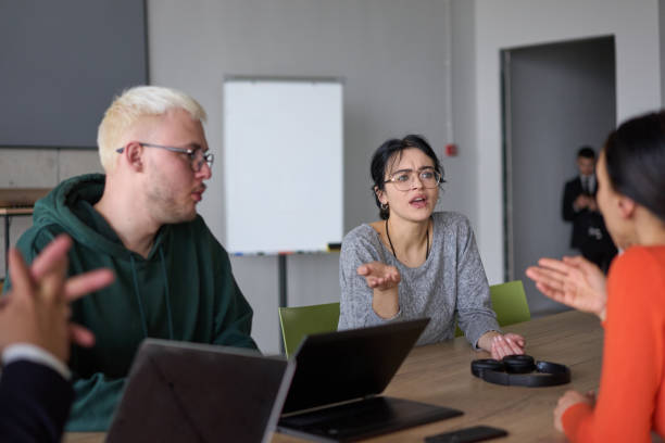 istock A young, diverse business team sitting together in a modern office, exchanging ideas and business plans, fostering collaboration and innovation for future success. 2195441424