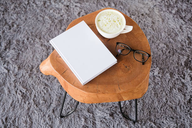 istock blank book mockup on white coffee table with green matcha tea near window 2195441426