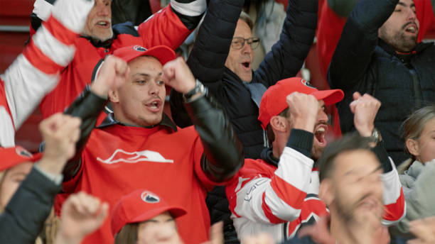 istock Diverse Crowd Cheering Passionately at Ice Hockey Game 2195442071