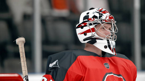 istock Focused Ice Hockey Goalie in Red Uniform 2195442202