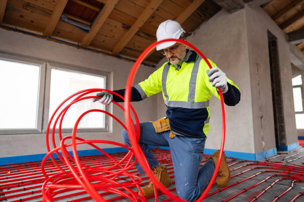 istock Construction Worker Installing Radiant Floor Heating with Red Tubing 2195443711