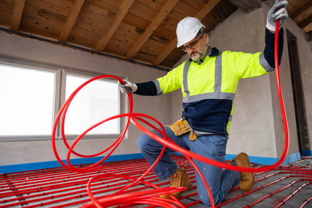 istock Construction Worker Installing Radiant Floor Heating Using Red Tubing Indoors 2195443751