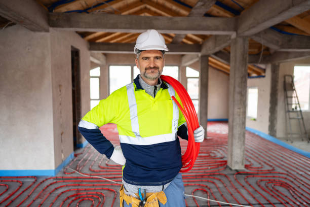 istock Portrait of Professional Worker Installing Underfloor Heating in a New Building Interior 2195444051
