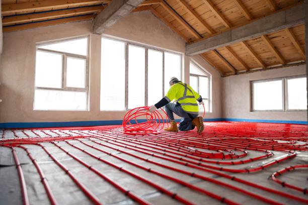 istock Worker Installing Red Tubing for Radiant Floor Heating System in New Building 2195444310