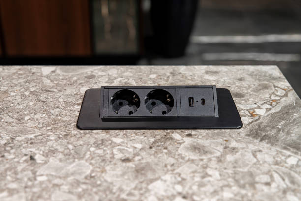 Modern power outlet with USB port on marble countertop surface