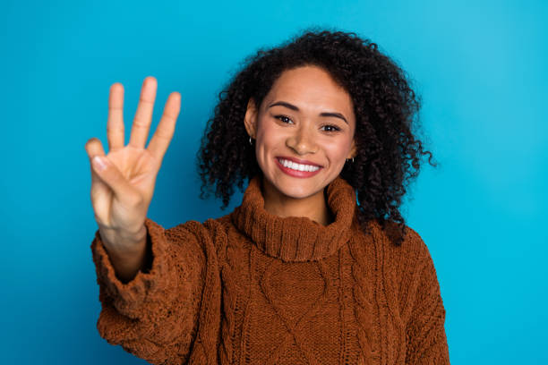 istock Cheerful young woman making a hand gesture with a vibrant blue background 2195449292