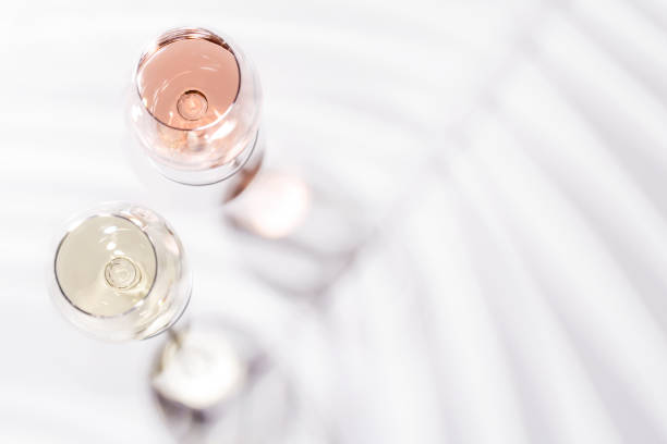 istock Two wine glasses filled with rose and white wine 2195450545