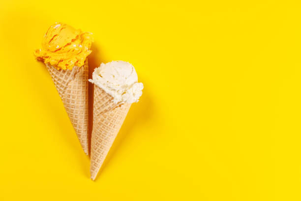istock A refreshing ice cream cones set against a vibrant yellow background 2195450673