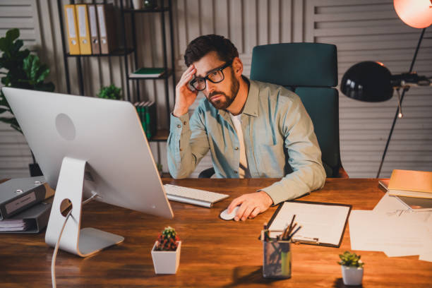 istock Professional young man working in a modern office space, focusing on a project 2195452668
