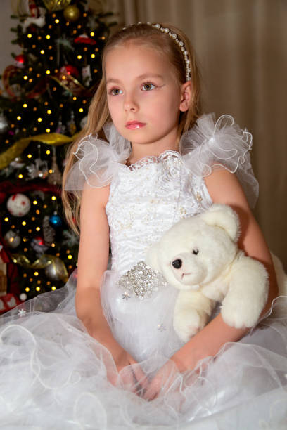 little girl decorating christmas tree