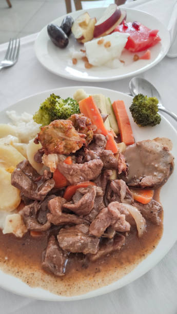 istock Beef stew with mashed potatoes, vegetables and fried dumplings served with fruit salad in an egyptian sataya resort 2195455706