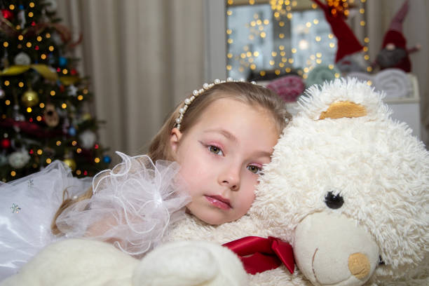 little girl decorating christmas tree
