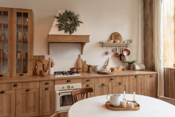 istock Rustic kitchen interior with wooden furniture and round dining table 2195458416