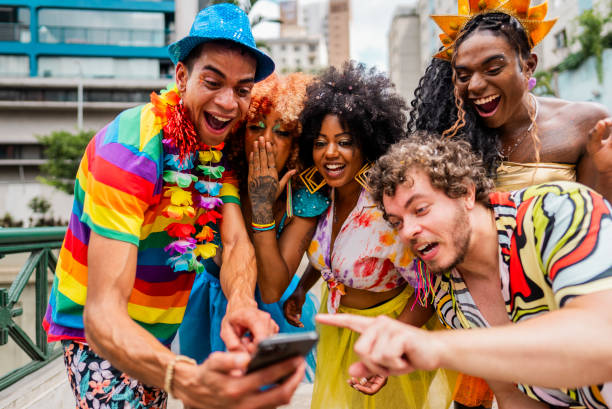 istock Friends using mobile phone at the street carnival 2195461297