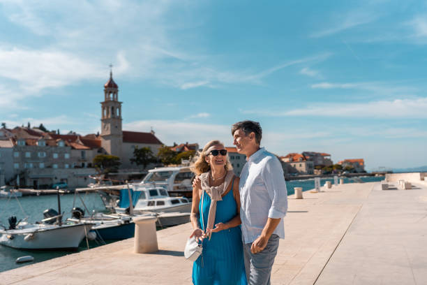 istock Mature Couple Strolling in Coastal Sutivan 2195461459