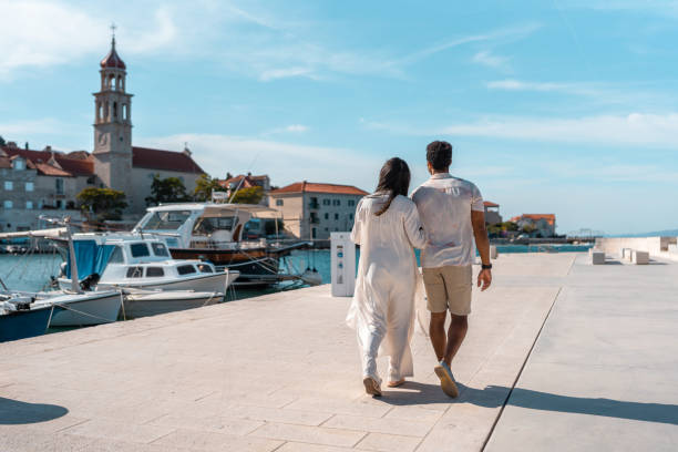 istock Diverse Couple Exploring Serene Coastal Town 2195461469