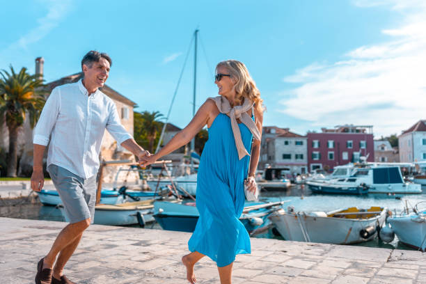 istock Mature Caucasian Couple Joyfully Running on Pier 2195461538