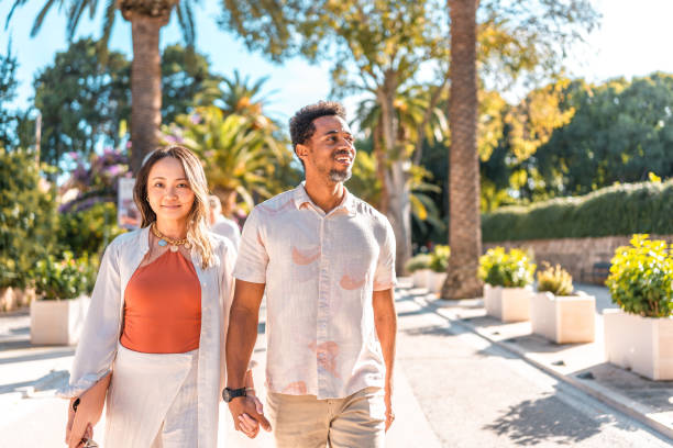 istock Joyful Couple Strolling Coastal Promenade 2195461559