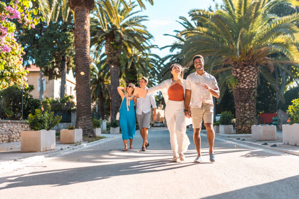 istock Elegant Diverse Couples Stroll Coastal Promenade 2195461564