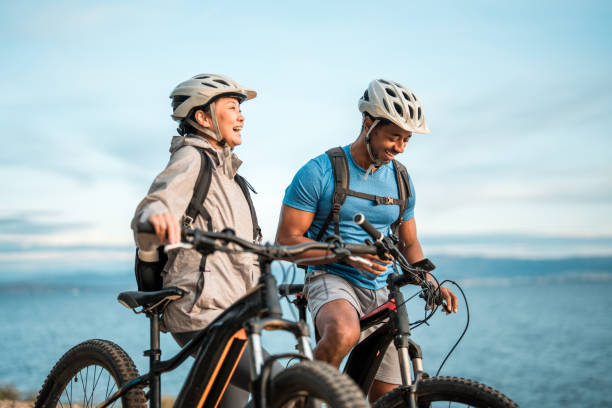 istock Active Couple with E-Bikes Enjoying Seaside Sunrise 2195462120