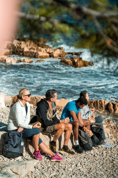 istock Diverse Group of Friends Savors Beach Picnic 2195462275