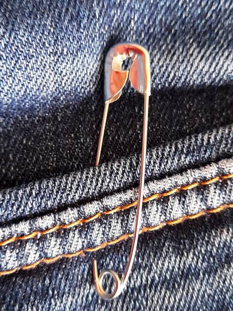 istock One metal safety pin with jeans 2195463597