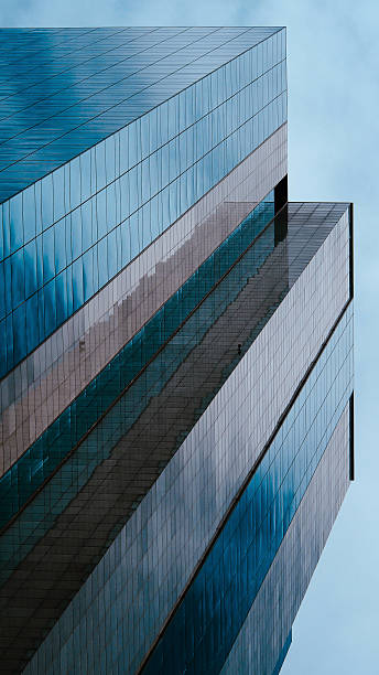 Vertical Elegance  A Dramatic Perspective of Modern Architecture, Highlighting Glass Facades and Geometric Design, Perfect for Urban Themes or Architectural Branding