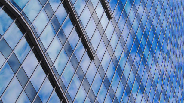 istock Dynamic Diagonal Reflection
A rhythmic interplay of diagonal glass panels reflecting the soft patterns of a cloudy sky. The architectural detail adds depth and movement to the composition. 2195464016