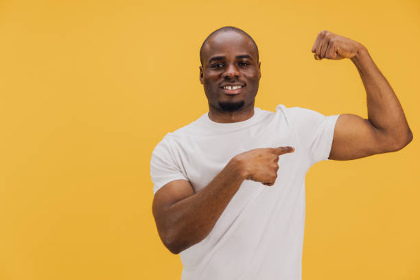 istock Young man showing his biceps and pointing at them with his finger 2195477328