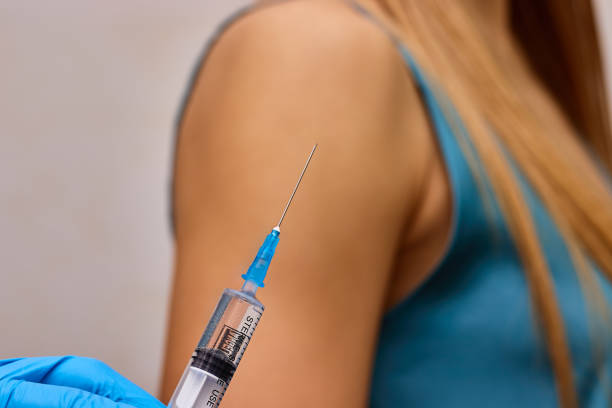 istock Vaccination concept. Vaccine syringe in doctor's hand. 2195478751