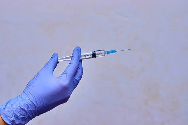 istock Syringe with a vaccine in doctor's hands. 2195479097