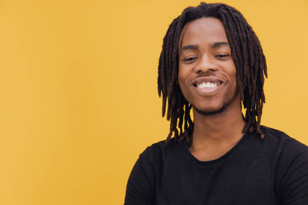 istock Young African American Man Smiling on Yellow Background 2195480066